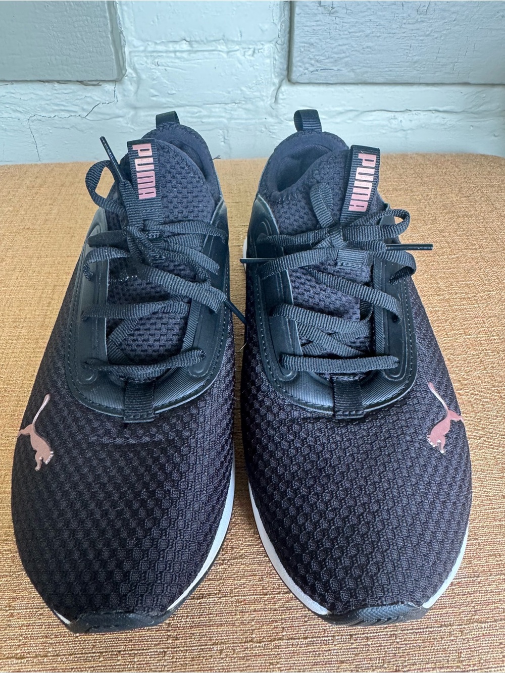 Puma women’s Black Athletic Sneakers with Pink Accents